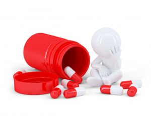 Open Red Pill Bottle with Red and White Capsules