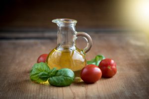 Fresh Basil, Tomato alongside Bottle of Oil