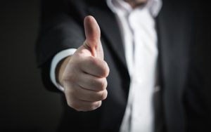 Man In Suit Giving Thumbs Up